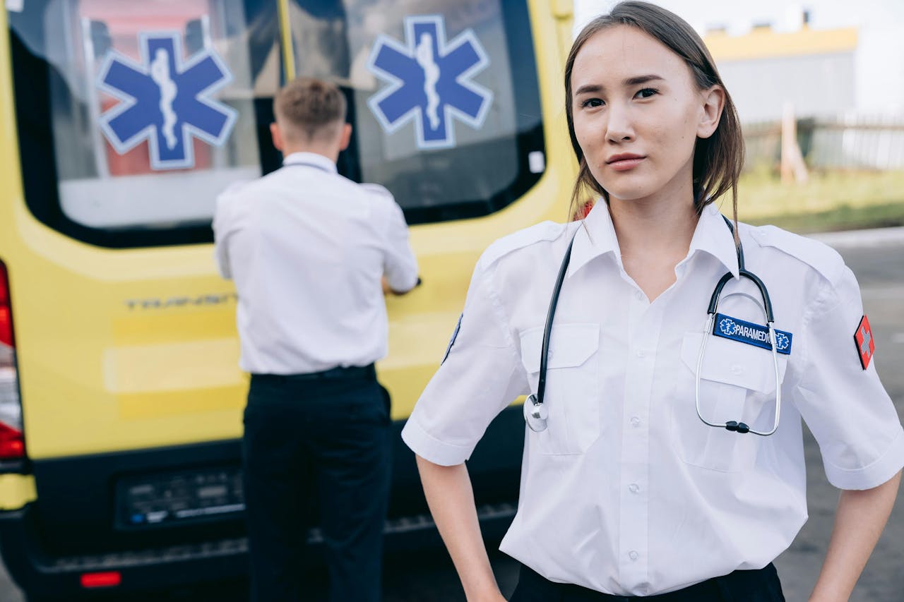 Woman Paramedic Standing against Ambulance